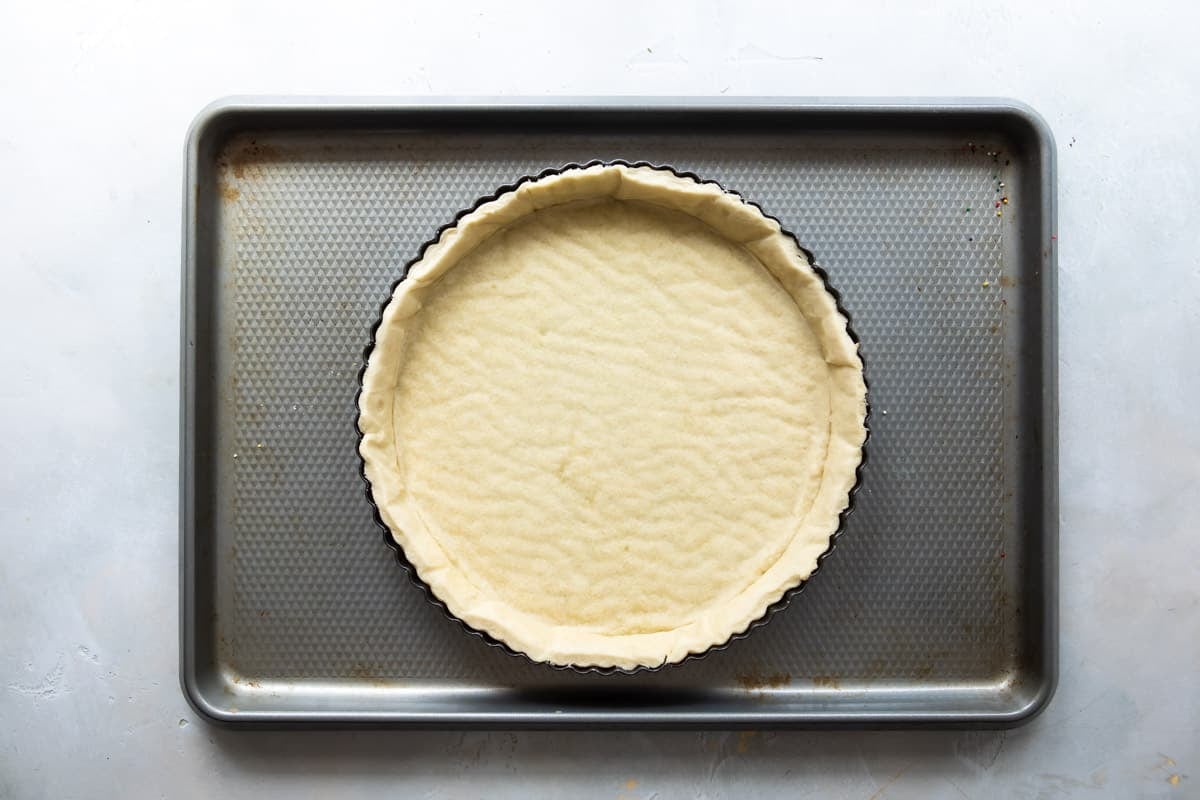 A tart crust on a baking sheet.