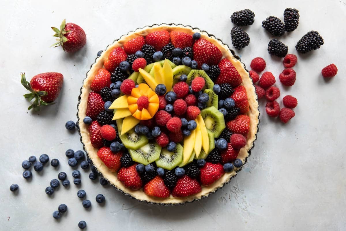 A whole, unsliced fresh fruit tart.