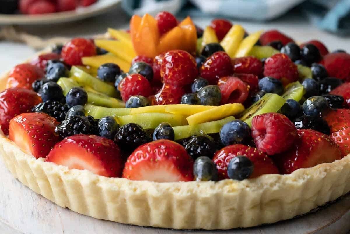A whole, unsliced fresh fruit tart.
