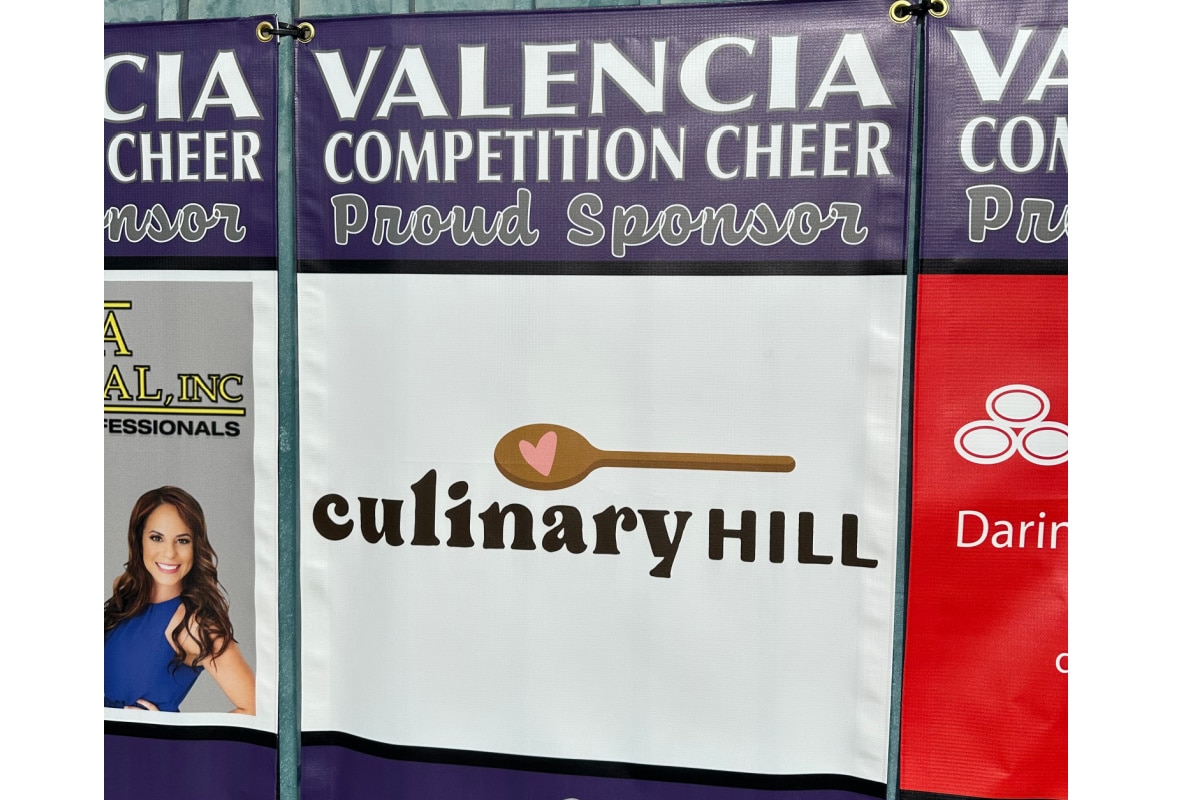 A banner with the culinary hill logo showing we sponsored the high school competition cheer team.