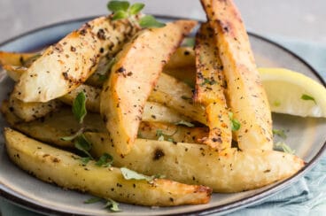 Greek roasted potatoes on a gray plate.