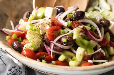 A Greek salad in a wooden bowl.