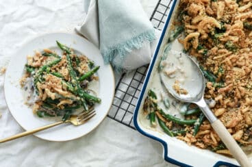A casserole dish and a plate full of green bean casserole.