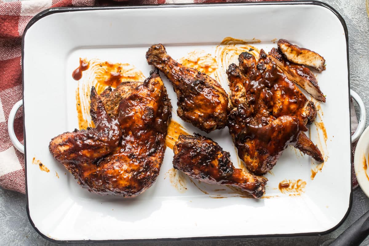 Barbecue chicken on a white platter.