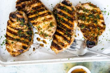 Grilled Pork Chops on a white platter.