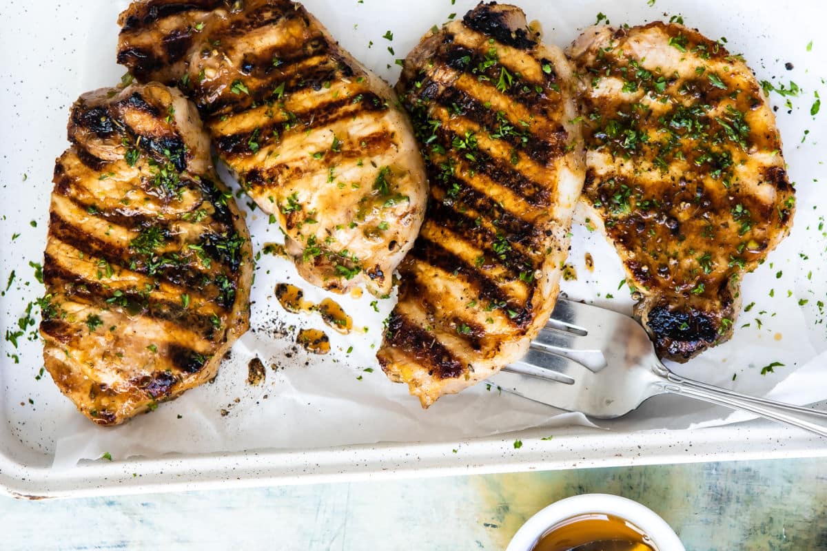 Grilled Pork Chops on a white platter.