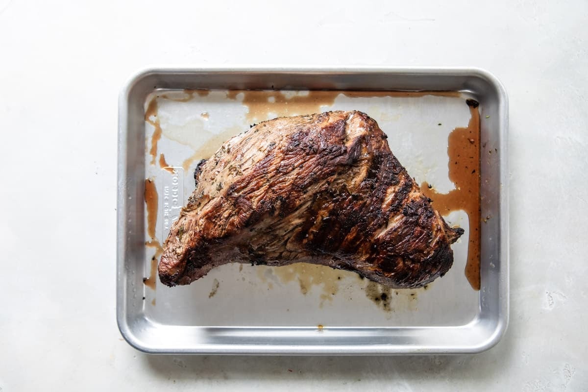 A tri-tip roast on a baking sheet.