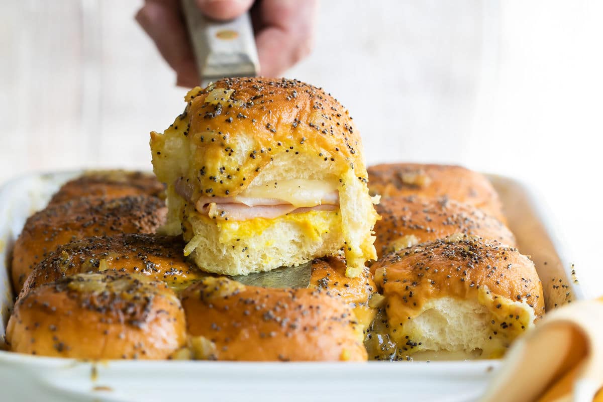 A baking dish of ham and cheese sliders.