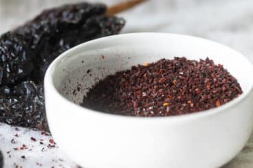Homemade Ancho Chile Powder in a white bowl.
