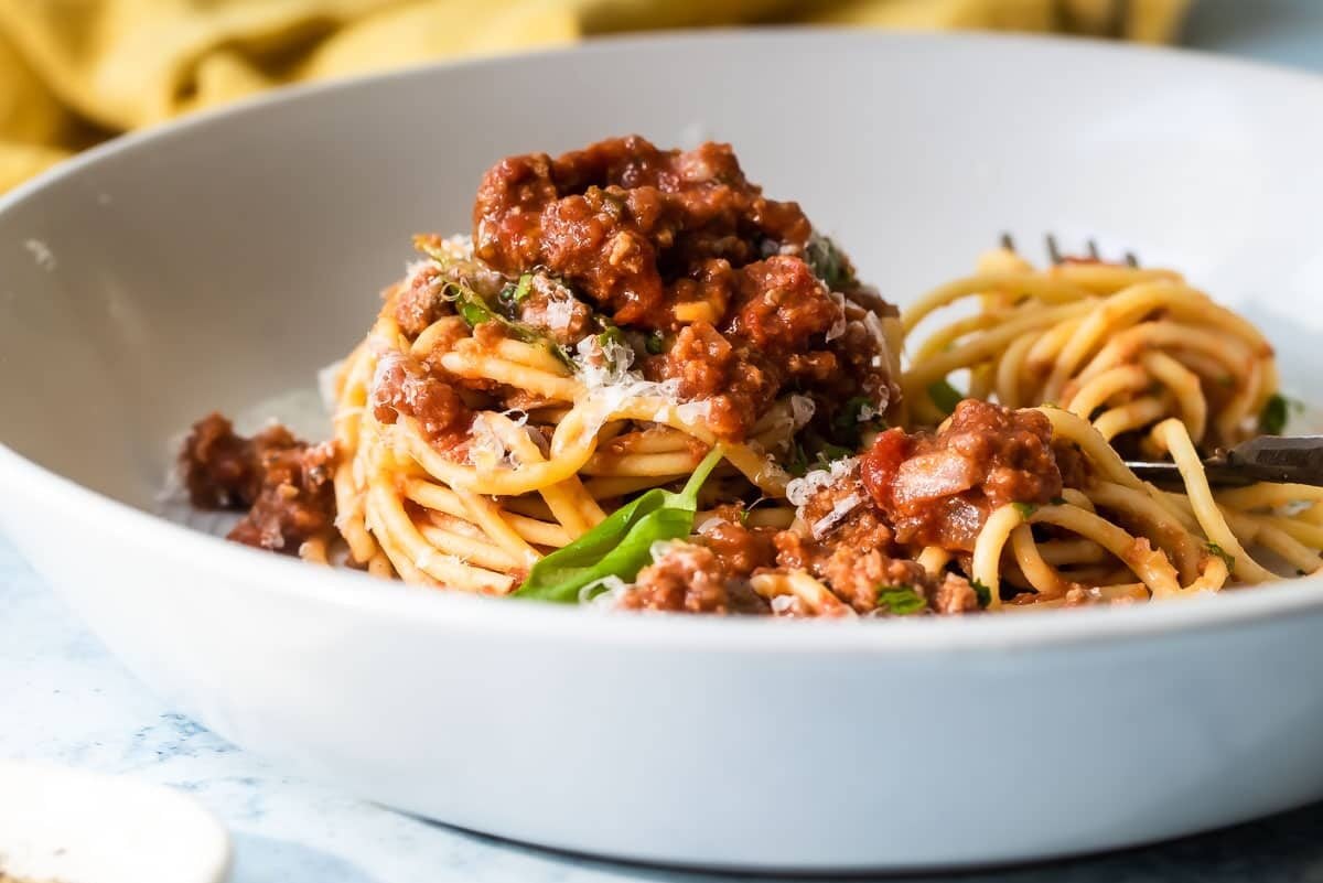 Spaghetti with sauce in a white bowl.