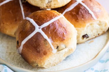 Hot cross buns on a gray platter.