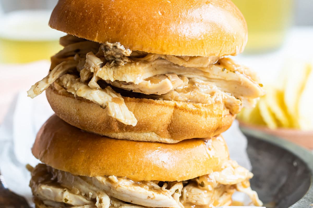 2 hot turkey sandwiches piled on a plate.