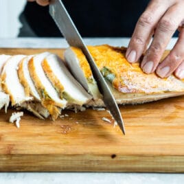 Carving roasted turkey breast into slices.