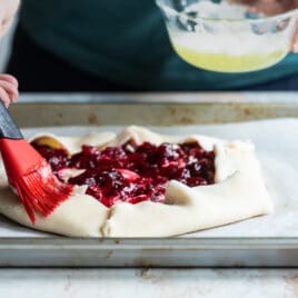 Brushing egg wash on a galette.