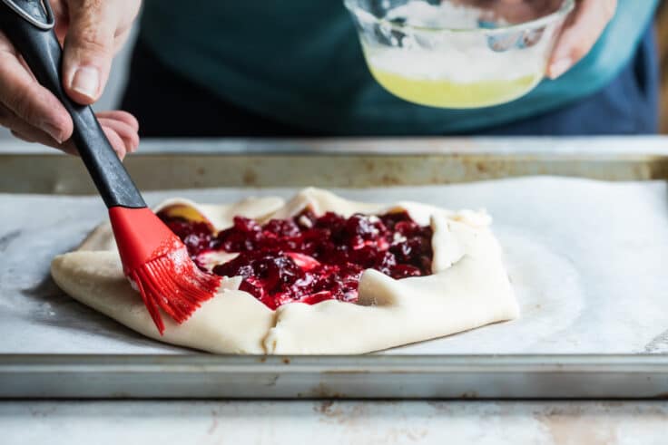Brushing egg wash on a galette.