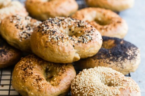 Homemade bagels on a cooling rack.