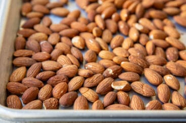 Whole almonds on a baking sheet.