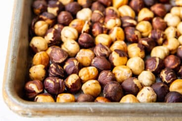 Hazelnuts roasted on a baking sheet.