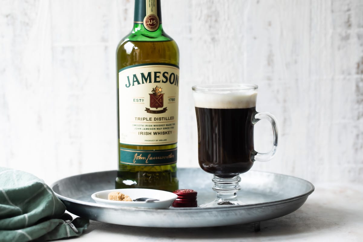 A tray with Irish Coffee and a bottle of Jameson Irish whiskey.