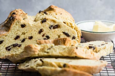 Irish soda bread sliced on a baking rack.