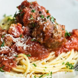Spaghetti and meatballs on a white platter.
