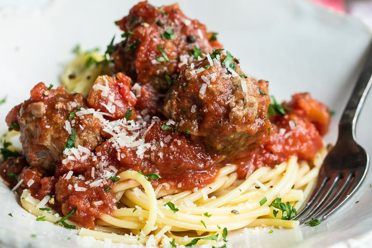 Spaghetti and meatballs on a white platter.
