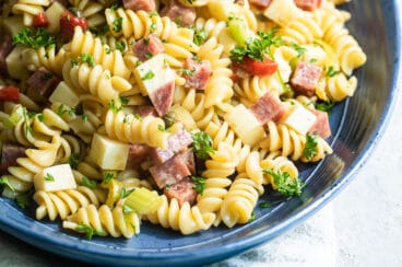 Italian pasta salad on a blue platter.