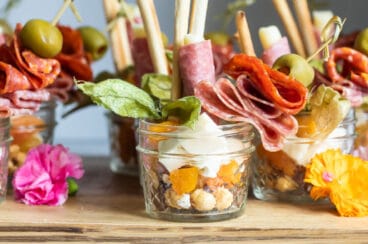 Jarcuteries on a wooden cutting board.