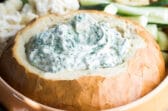 A bread bowl filled with Knorr Spinach Dip.