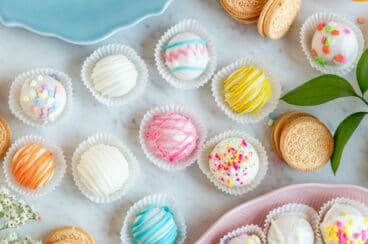 Lemon cookie balls decorated and arranged on a table.