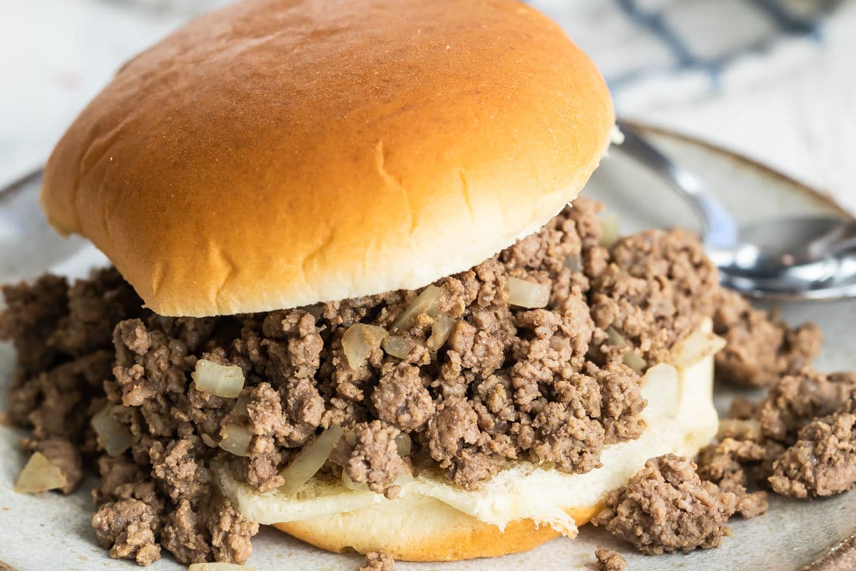 A loose meat sandwich on a plate.