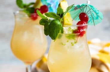 Two Mai Tai cocktails on a counter.