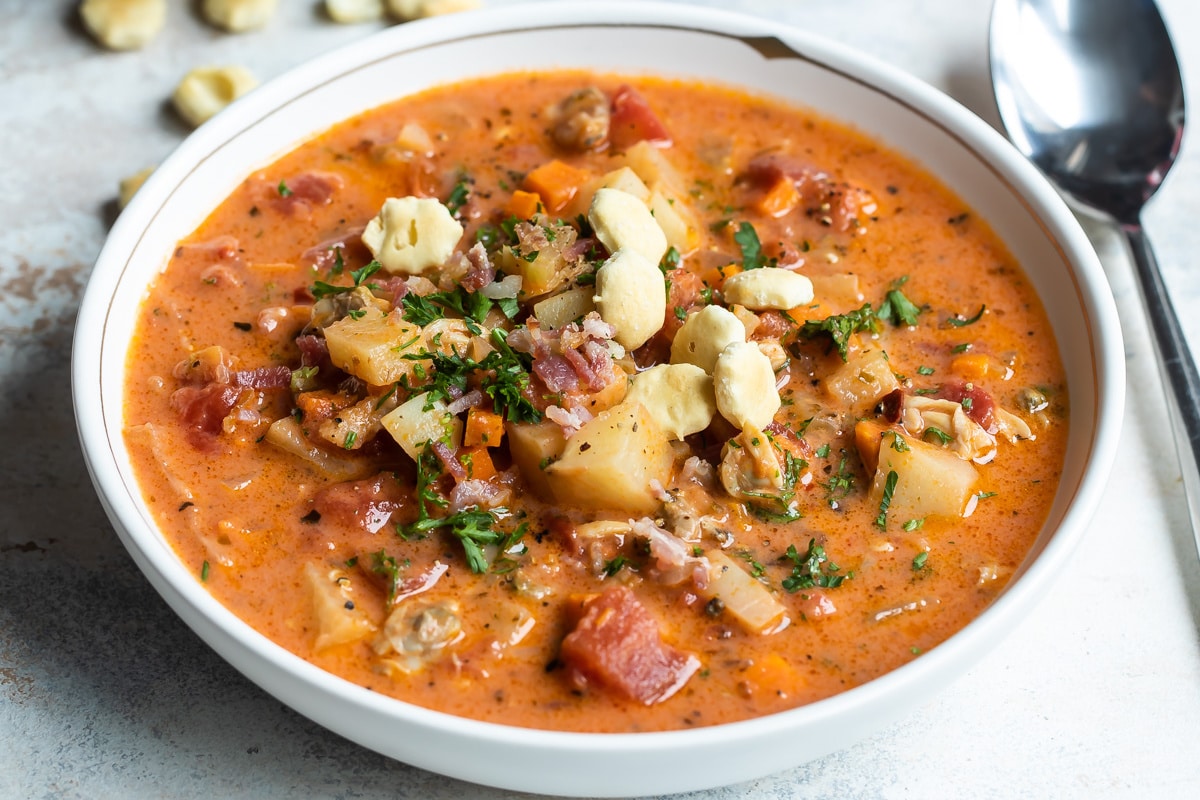 A white bowl filled with Manhattan clam chowder.