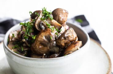 Marinated mushrooms in a gray bowl.