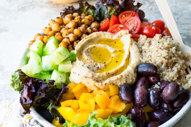 A Mediterranean Buddha bowl on a gray counter.