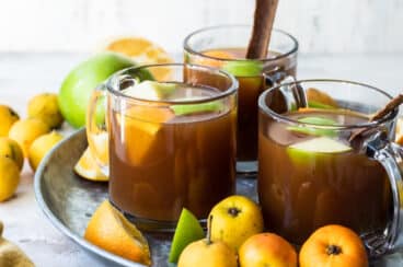 Mexican Christmas punch on a serving tray surrounded by fruits.