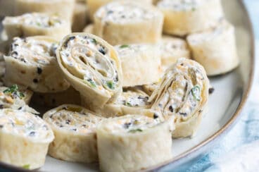 Mexican Tortilla roll ups on a serving platter.