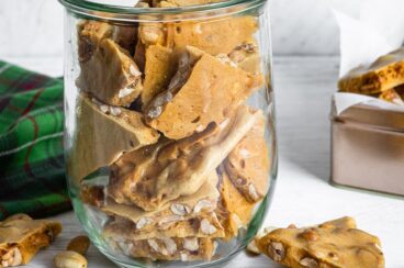 Microwave peanut brittle in a clear jar.