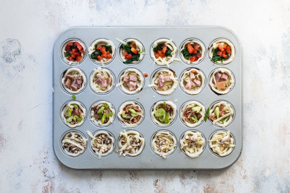Mini quiche built in a mini muffin tin.