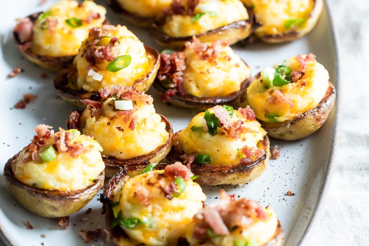Mini twice baked potato skins on a platter.