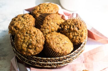 A brown basket filled with morning glory mufins.