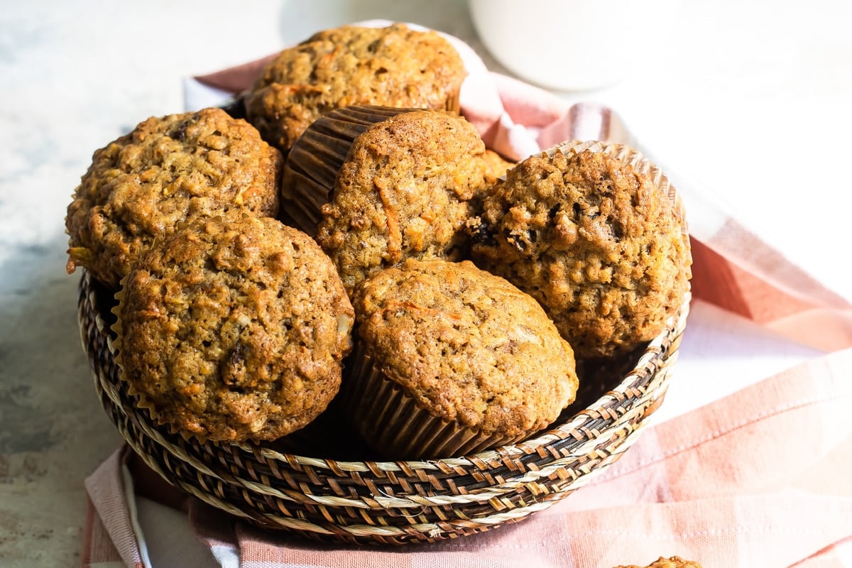 A brown basket filled with morning glory mufins.