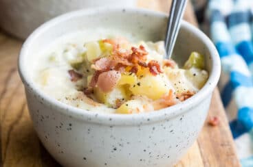New England clam chowder in a white bowl.