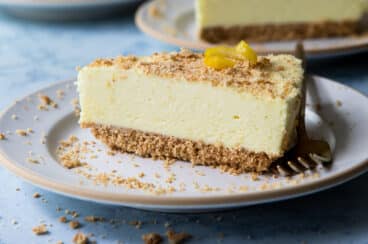A slice of no bake lemon cheesecake on a small plate.