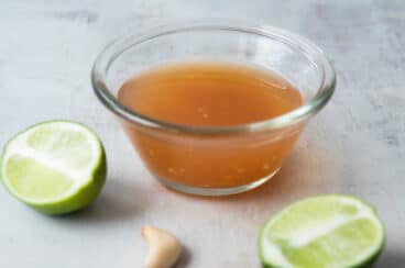 A clear glass bowl of Nuoc Cham.