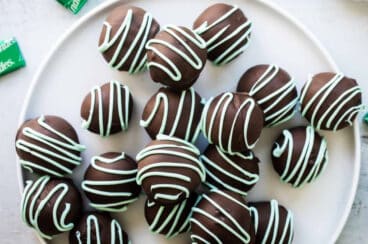 No bake mint Oreo truffles on a white plate.