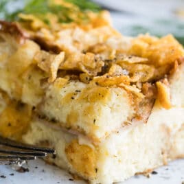 Overnight breakfast casserole on a white plate.