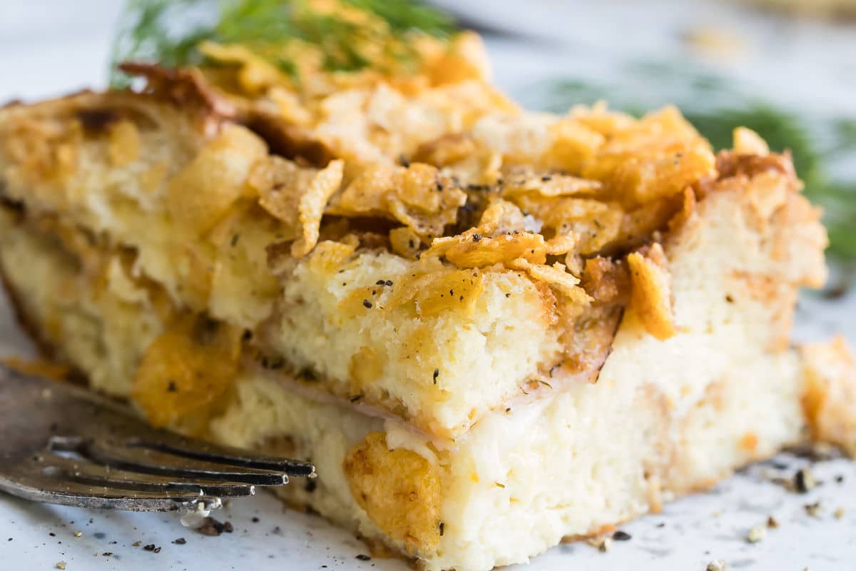 Overnight breakfast casserole on a white plate.