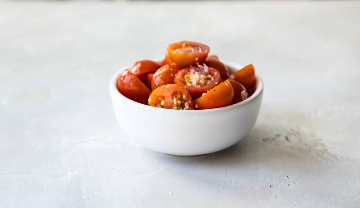 Tomatoes marinating in spices and olive oil.
