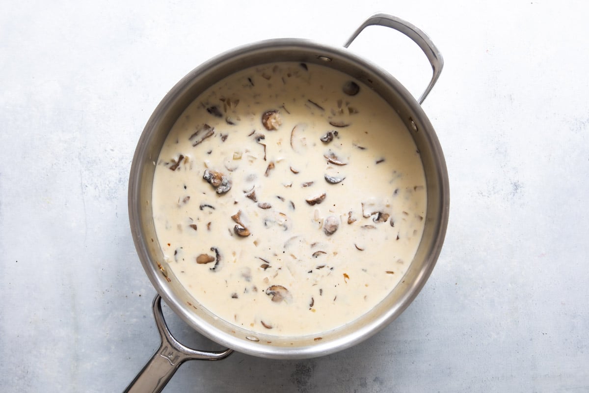 Creamy mushroom sauce in a skillet.